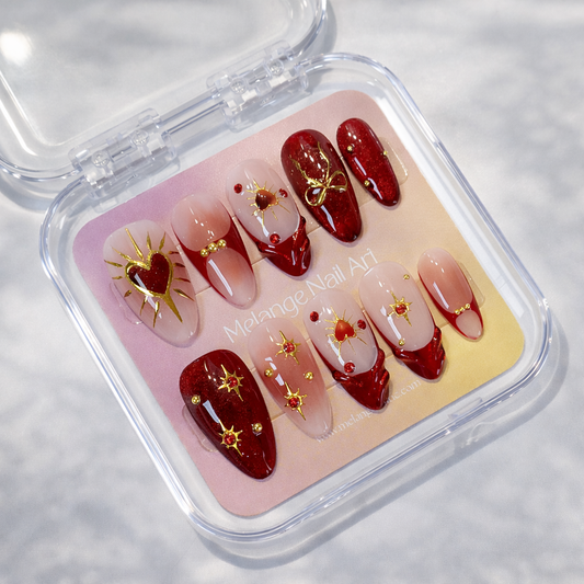 Set of red and gold nail art designs in a clear case on a light background