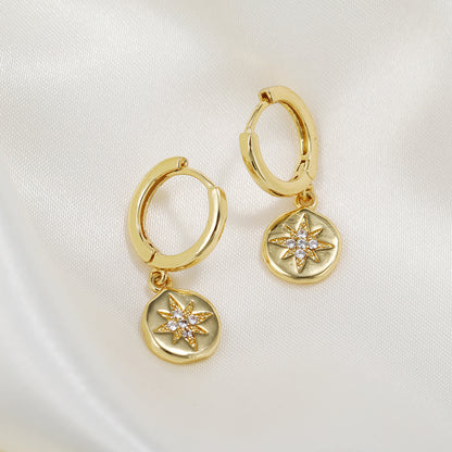 E056 gold starburst dangle earrings